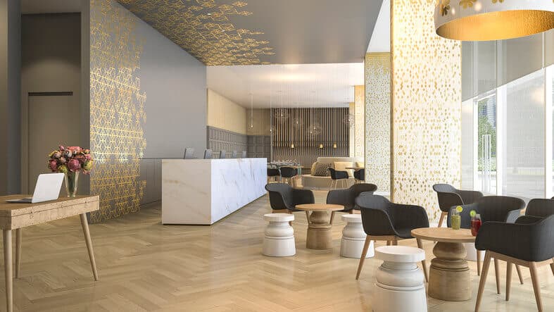Upscale hotel lobby with gold lattice panels, marble front desk, and herringbone wood floor